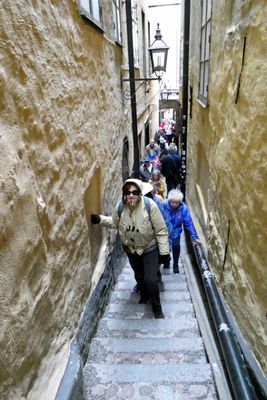 Susan climbing the narrowest stairway in Stockholm, Sweden