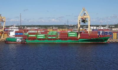 Container ship being loaded at the Daugava River port in Latvia