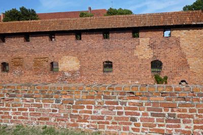 Restoration with different color bricks on Malbork Castle with darkest bricks from 1280