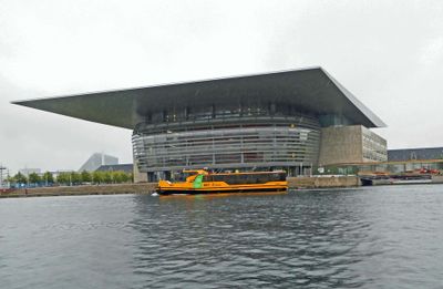 Copenhagen Opera House with 'harbor bus' passing in front
