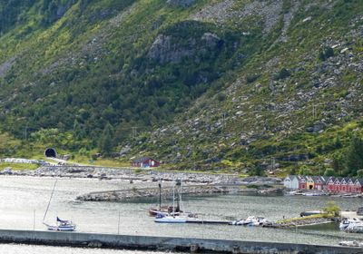 Boats, Colorful dock houses, and tunnel entrance in Alnes, Norway on Godoy Island