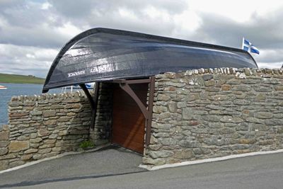 Garage roof is the mail boat that served the Shetland island of Foula from 1909 until the 1950's