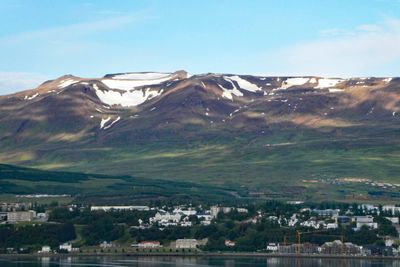 Snow on the mountains behind Akureyri, Iceland on July 19, 2023