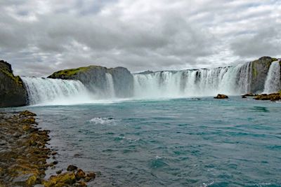 Photo of Godafoss waterfall from the bank of the Skjálfandafljót River in Iceland