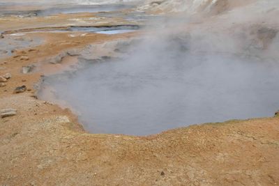 Hard to photograph bubbling mud pool at Namafjall Geothermal Area with all the steam