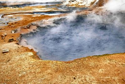 Hard to photograph bubbling mud pool at Namafjall Geothermal Area with all the steam