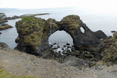 'Gatklettur' is an eroded circular stone arch along the Arnarstapi hiking path