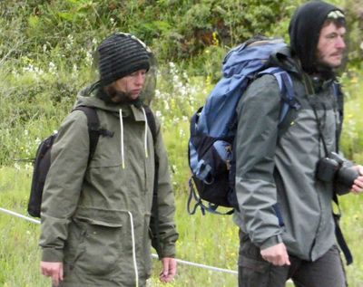 People on hiking trail wearing nets to combat the midges which don't bite, but are annoying