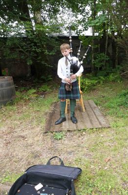 Young entrepreneur playing bagpipes in Inverary, Scotland