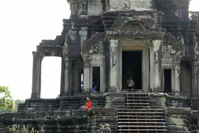 Lady meditating at north entrance to Angkor Wat