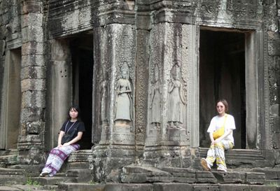 Girls posing for photos at Bayon Temple in Cambodia