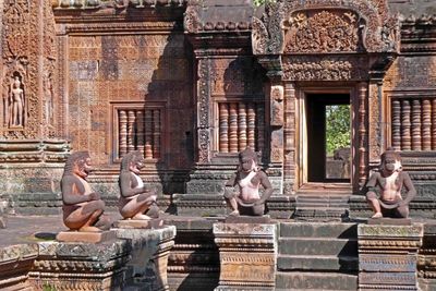 Monkey statues guard the entrance to the temple at Banteay Srei