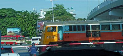 Waiting at train crossing in downtown Bangkok