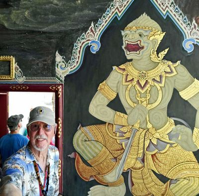 Bill beside mural of a character from Ramakien (one of Thailand's national epics)