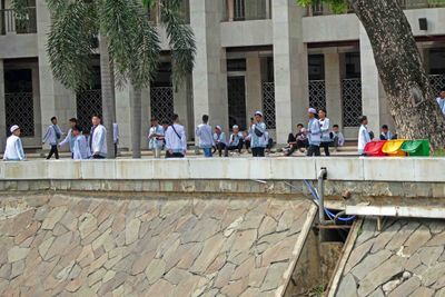 Young men waiting to enter Istiqlal Mosque