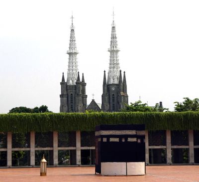 Jakarta Cathedral behind a replica of the 'Kaaba' (lthe most sacred site in Islam) at Istiqlal Mosque