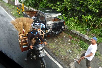 Broom salesman on the road in Central Java, Indonesia