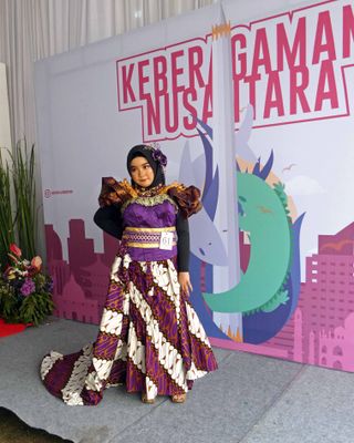 Young girl participating in exhibition of Indonesian dress