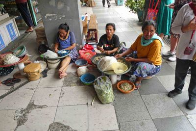 Ladies preparing bean sprouts outside Genteng Market in Surabaya