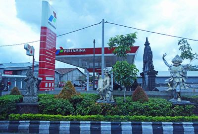 Statues in front of gas station in Bali