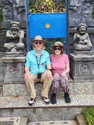 Sitting with guardians at the gate to a temple in Ulun Danu Beratan
