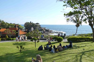 Families enjoying a nice day at Tanah Lot temple in Bali