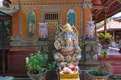 Ganesha statue with daily offerings in modern Balinese house