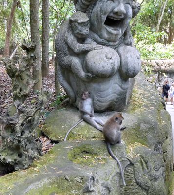 Young monkees beside a statue in the Monkey Forest Sanctuary, Ubud