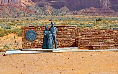 Great Seal of the Navajo Nation and Bronze Navajo Family Statue at the entrance of Monument Valley