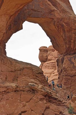 People climbing into the lower of the Double Arches