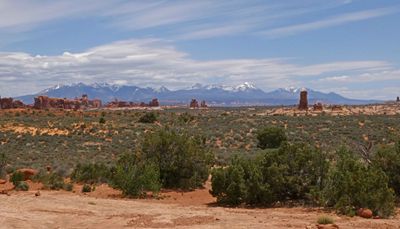 Turret Arch formation in Arches National Park in front of Lasal Mountains in Utah