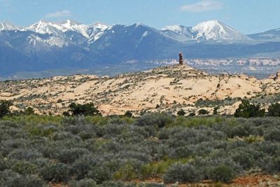 Lone Pillar in Arches National Park with LaSal Mountains behind