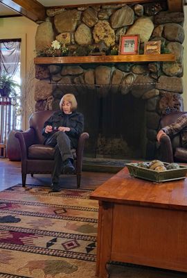 Susan in front of fireplace in Custer State Game Lodge