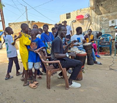 Children and musicians in the village of Nofry, Senegal.jpg