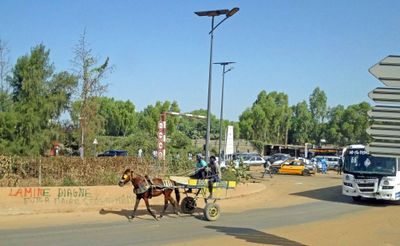 Horse carts share the road with cars and trucks around Dakar.JPG