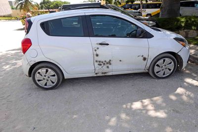 Car with repaired bullet holes in Senegal.JPG