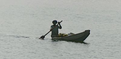 Gambian in a dugout canoe on the Gambia River.JPG