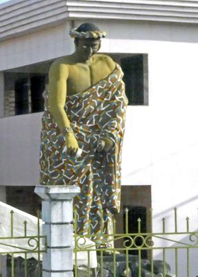 Statue of servant pouring a drink stands in front of the residence of the King of Grand Bassam, Ivory Coast.JPG
