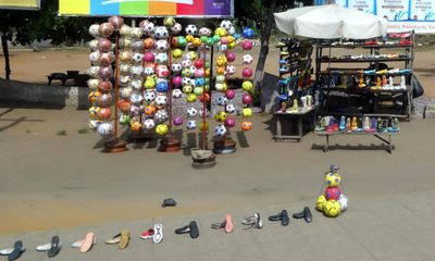 Soccer balls and shoes for sale along the road in Loma, Togo.JPG