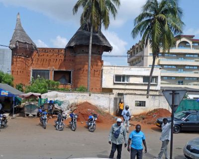 Togo tradtional archicture next to modern building in Loma, Togo.JPG