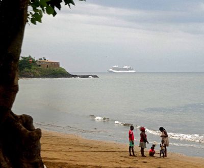 Kids on the beach at Pantufo with RSSC Splendor docked in the Gulf of Guinea.JPG
