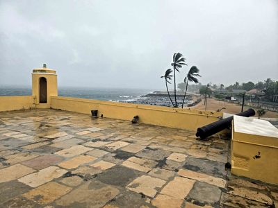 View in the wind (note the palm trees) and rain from the top of Sao Tome Fort.jpg