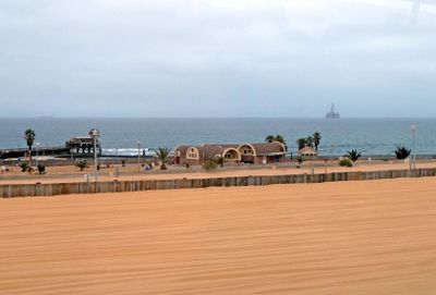 Houses and offshore oil rig between Walvis Bay and Swakopmund, Namibia.JPG