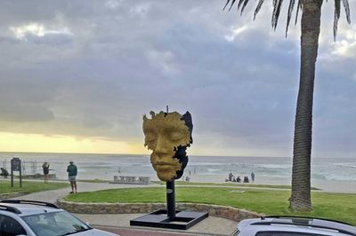 Bronze sculpture by Marco Olivier on the beach at Camp's Bay, Cape Town.jpg
