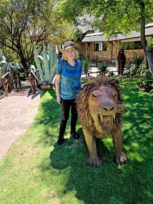 Susan with Lion statue at Aquila Game Reserve.jpg