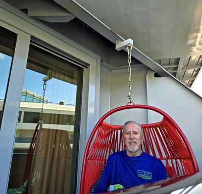 Bill on the balcony of our cabin on the Resilient Lady
