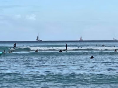 Surfers on Waikiki Bay