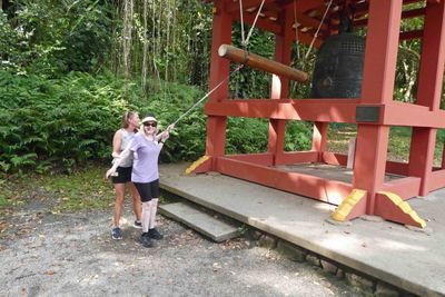Barbara helping Susan ring the Bon-Sho (sacred bell)
