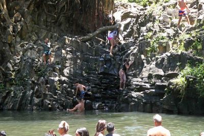 Kids climbing to the top of Twin Falls in Maui