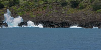 Waves breaking of the rocks along the Kona coastline